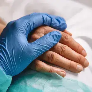 Doctor holding patient's hand